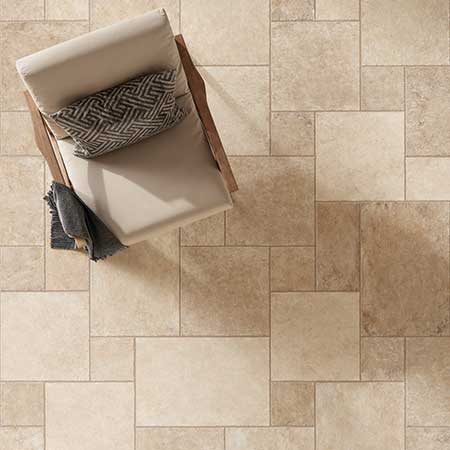 Close-up of Pietra di Trani Avorio porcelain tile installed in a modular limestone pattern.