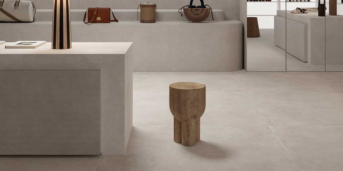 Bowery White concrete-look porcelain tile installed in a contemporary retail space