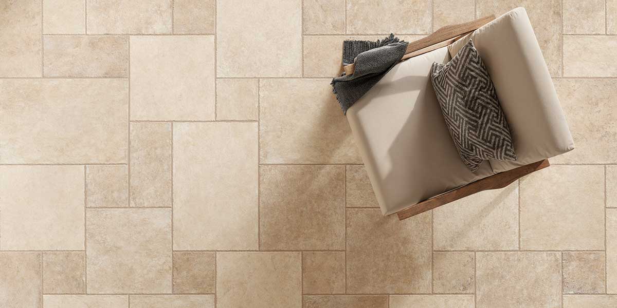 Close-up of Pietra di Trani Avorio porcelain tile installed in a modular limestone pattern.