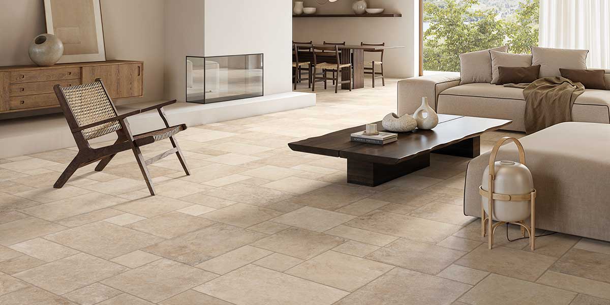 Modern living room featuring Pietra di Trani Avorio stone-look porcelain tile flooring in a modular pattern.