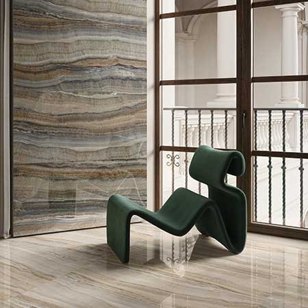 Contemporary living space featuring Astral Amber onyx-look porcelain tile floor and statement wall.