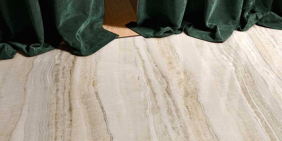 Close-up of Astral Beige onyx-look porcelain tile flooring with natural stone veining.