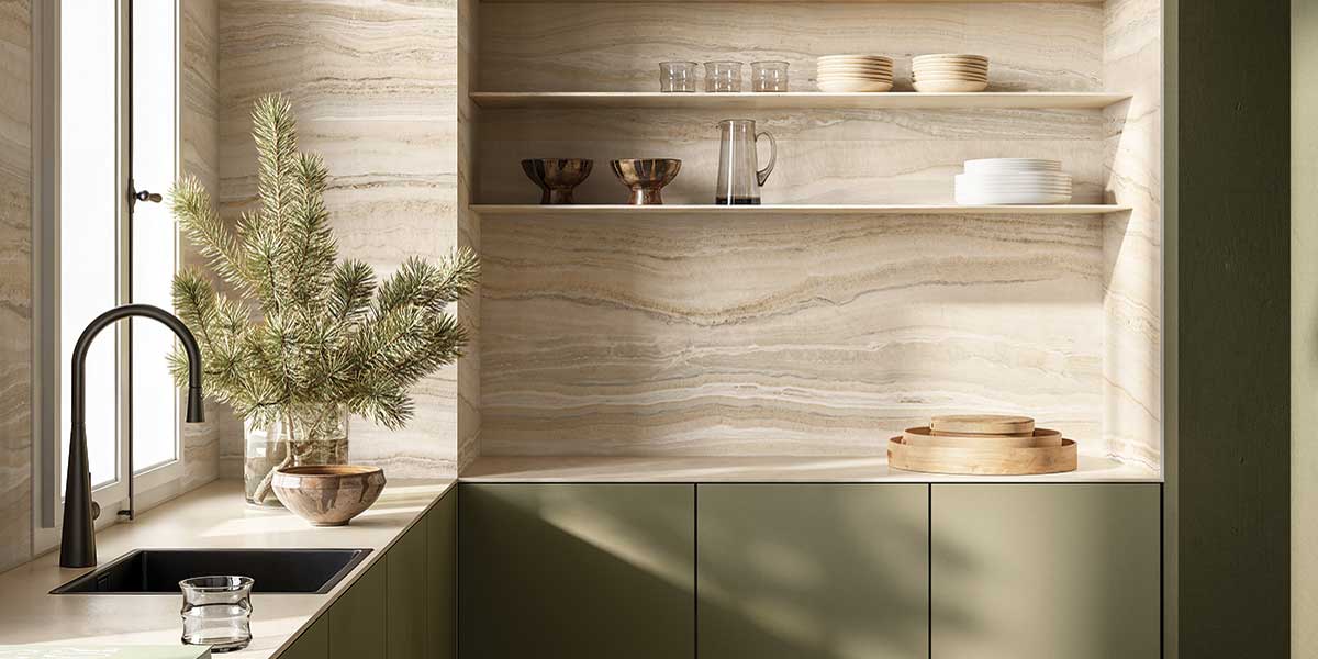 Modern kitchen featuring Astral Beige onyx-look porcelain tile on walls and countertops.
