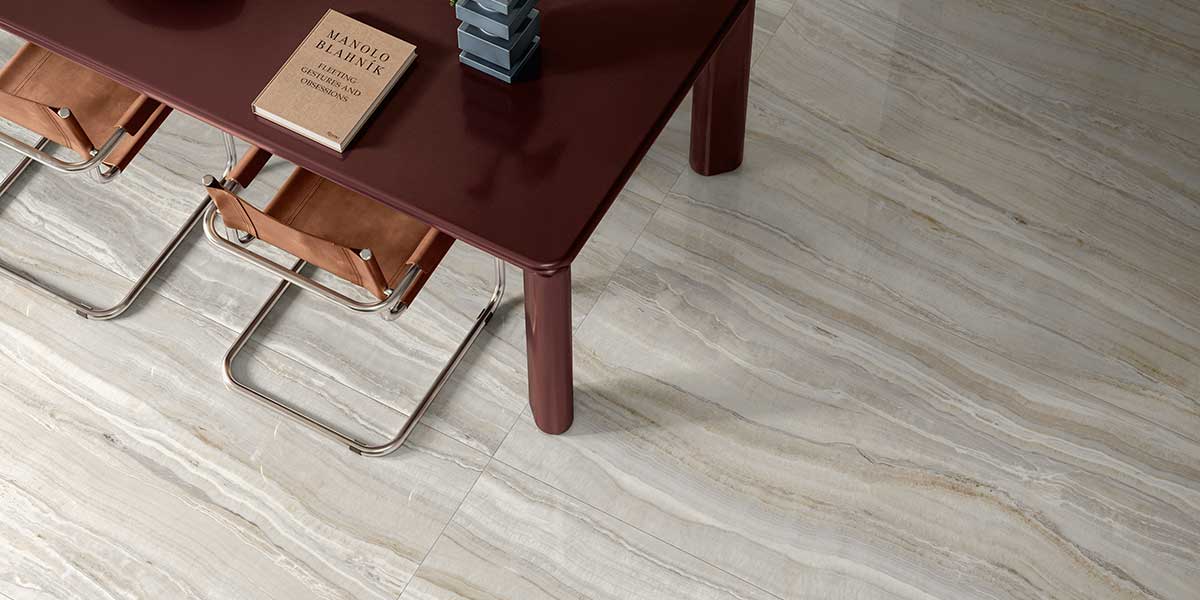 Modern dining room featuring Astral Pearl onyx-look porcelain tile flooring.