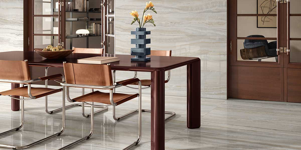 Open-concept dining area featuring Astral Pearl onyx-look porcelain tile flooring and walls.