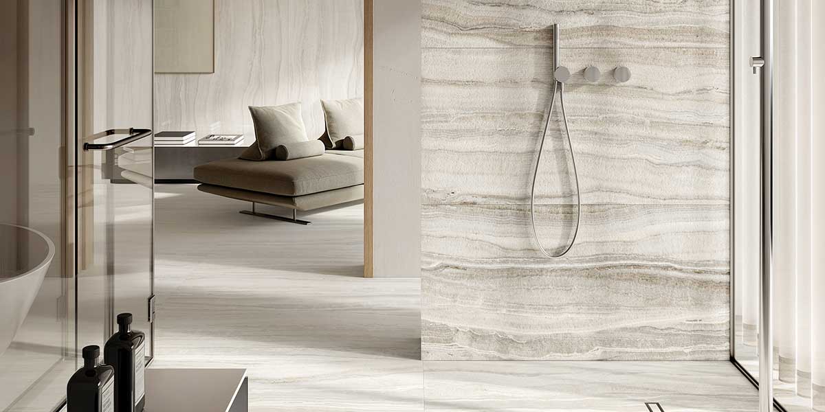 Luxury bathroom featuring Astral White onyx-look porcelain tile flooring and shower walls.