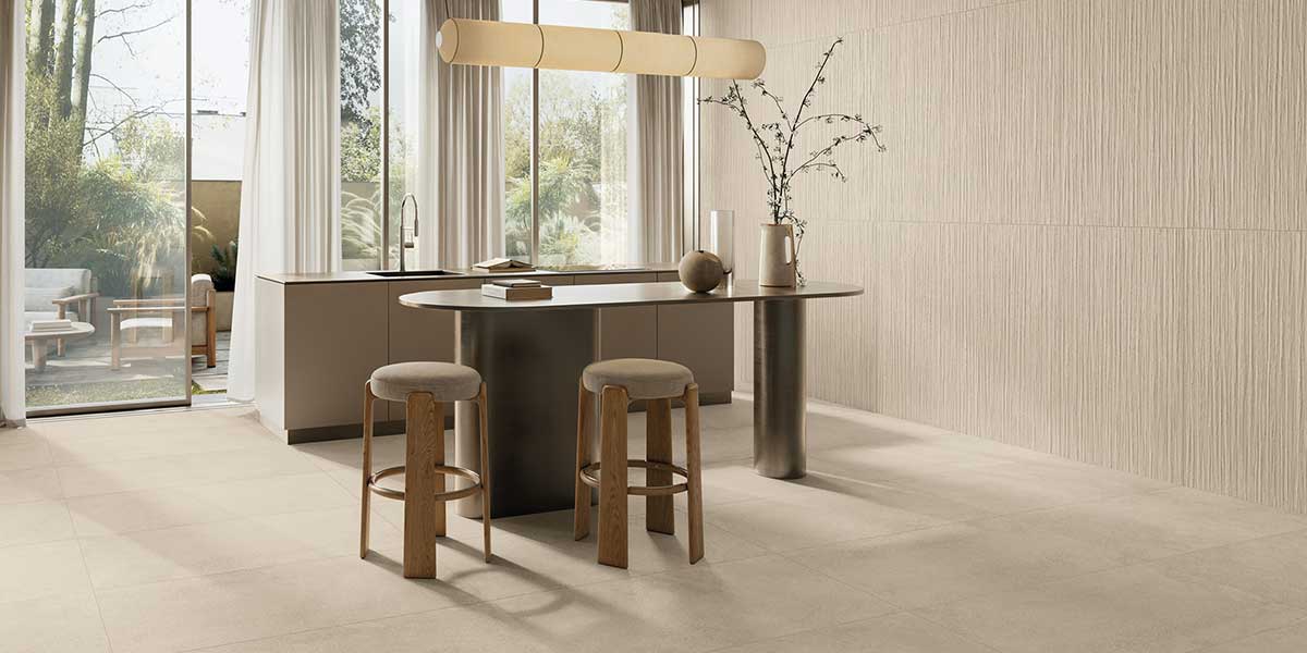 Modern kitchen featuring Pure Concrete Beige concrete-look porcelain floor tile and textured feature wall.