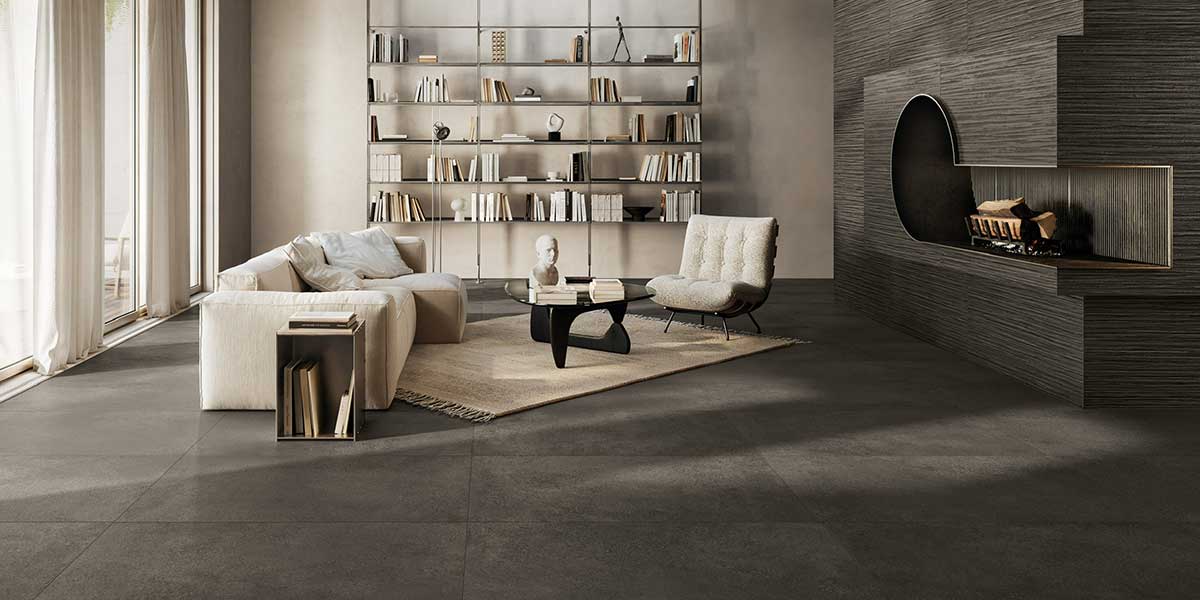 Modern fireplace featuring Pure Concrete Black concrete-look porcelain tile floor and textured wall.