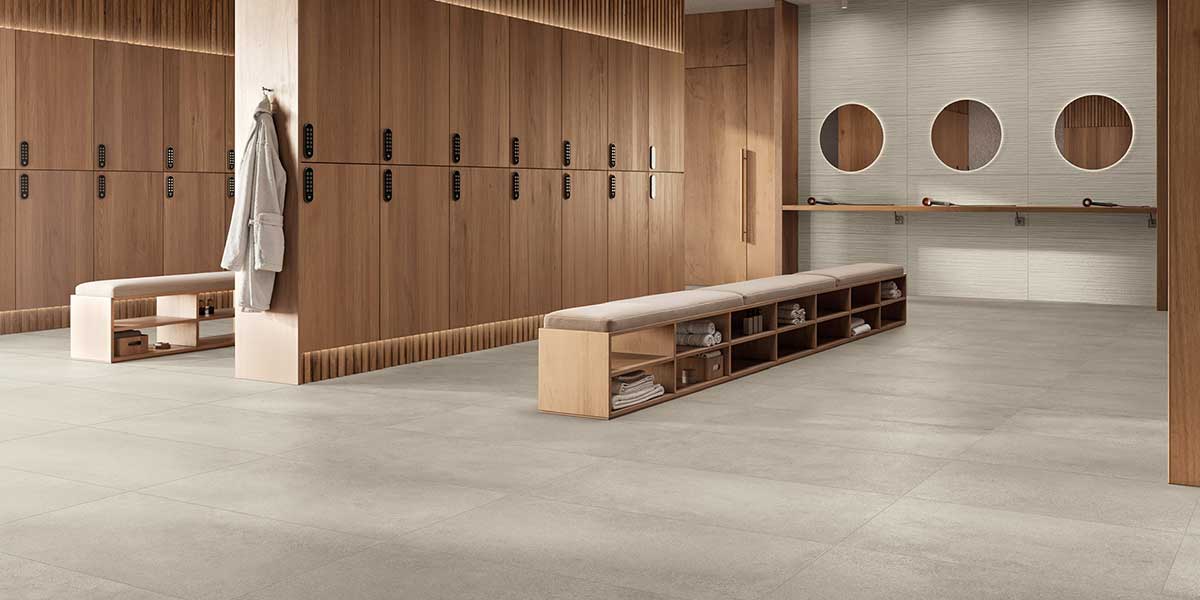 Luxury locker room featuring Pure Concrete Greige concrete-look porcelain floor tile.