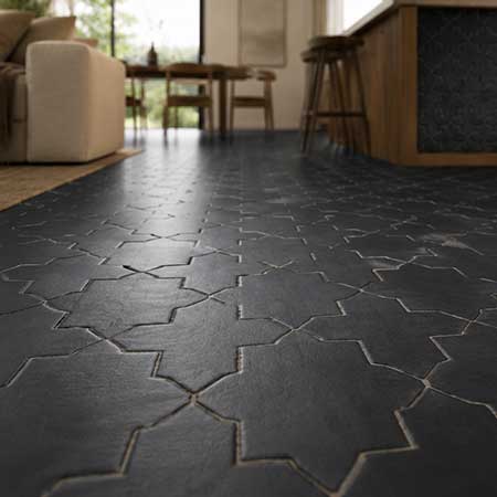 Low-angle view of Star & Cross Black matte porcelain tile flooring.