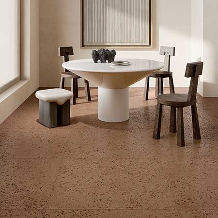 Bits Brick terrazzo-look porcelain floor tile in a contemporary dining room with dark wood furniture.
