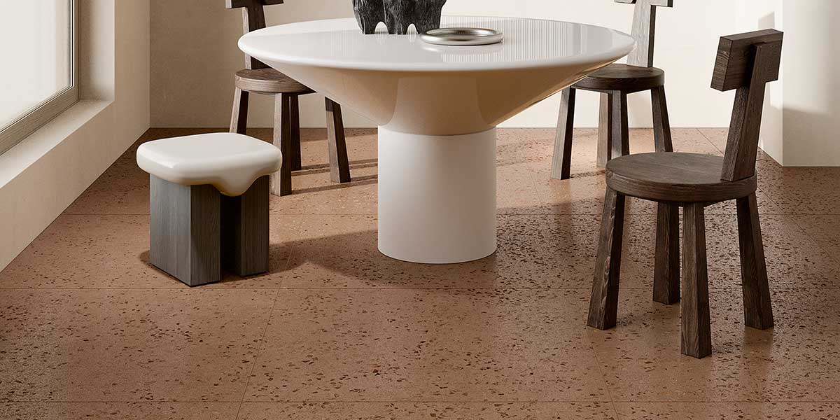 Bits Brick terrazzo-look porcelain floor tile in a contemporary dining room with dark wood furniture.