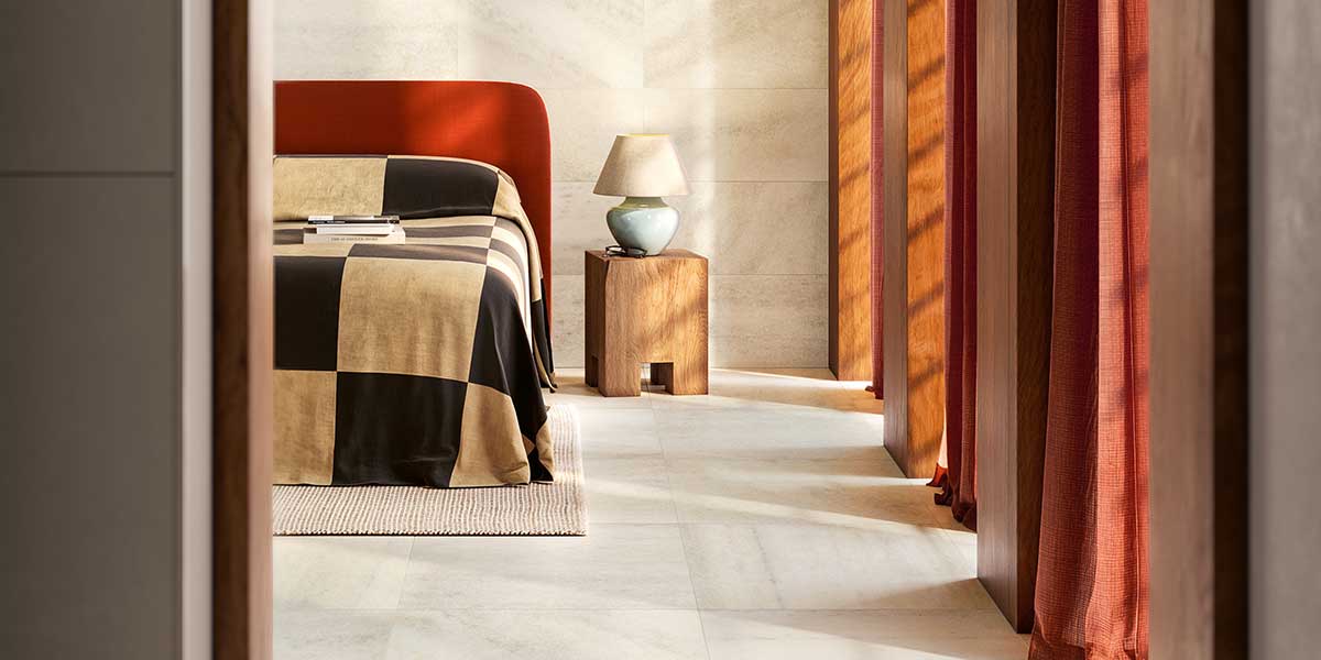 Milano Sublime Lume porcelain tile installed on the walls and floor of a contemporary bedroom.